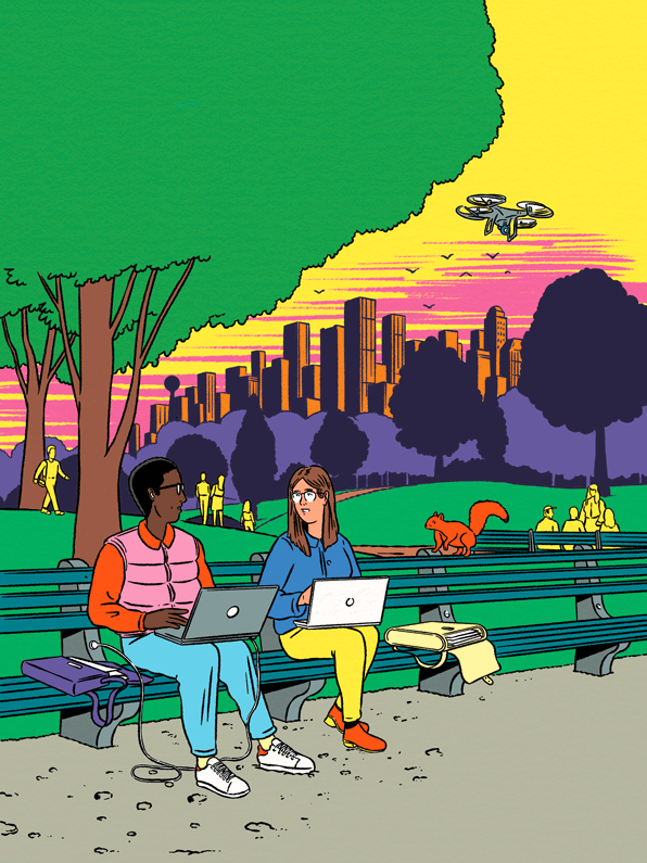 couple with laptop sitting on a bench in a park