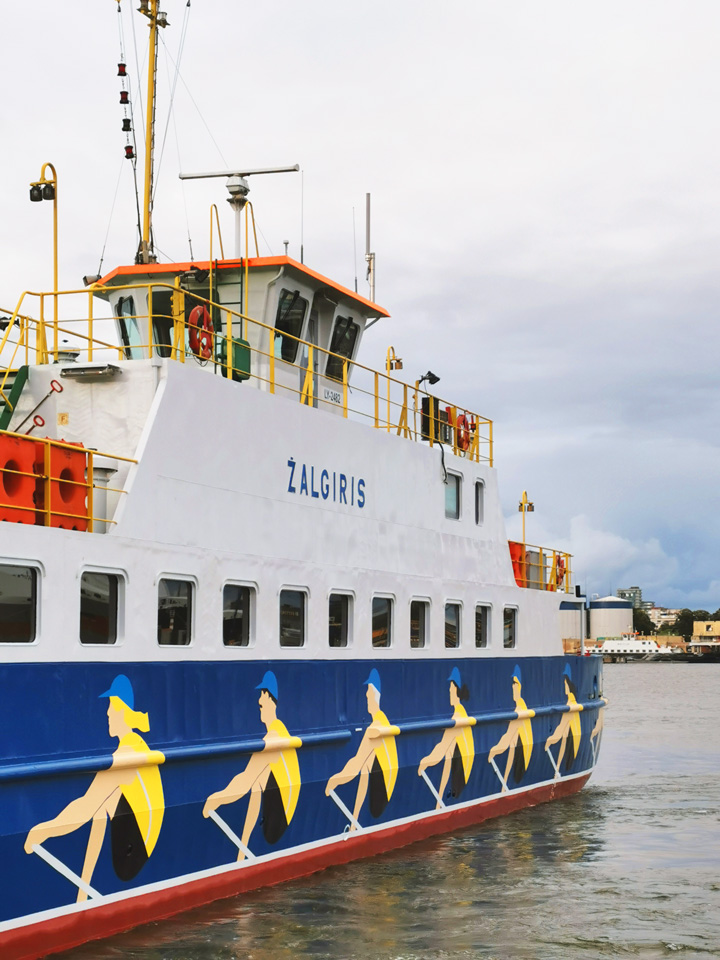 detail of ferry with painted rowers on side 