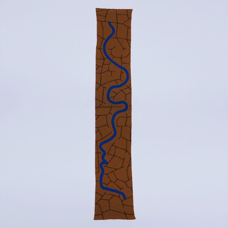 scarf with the pattern of the desert and a river that shows an outline of a face 