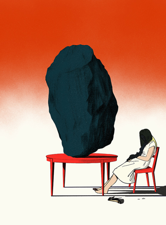 a woman sitting on a chair with a big stone on the desk in front of her that causes a big shadow on her