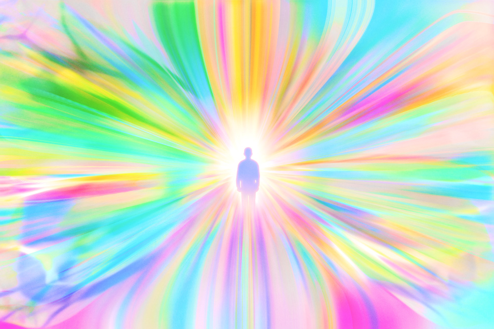person standing in center of abstract color gradients