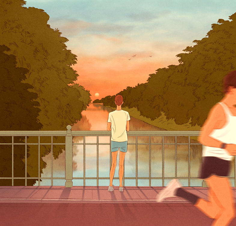 young thin man looks at the Alster in the evening light